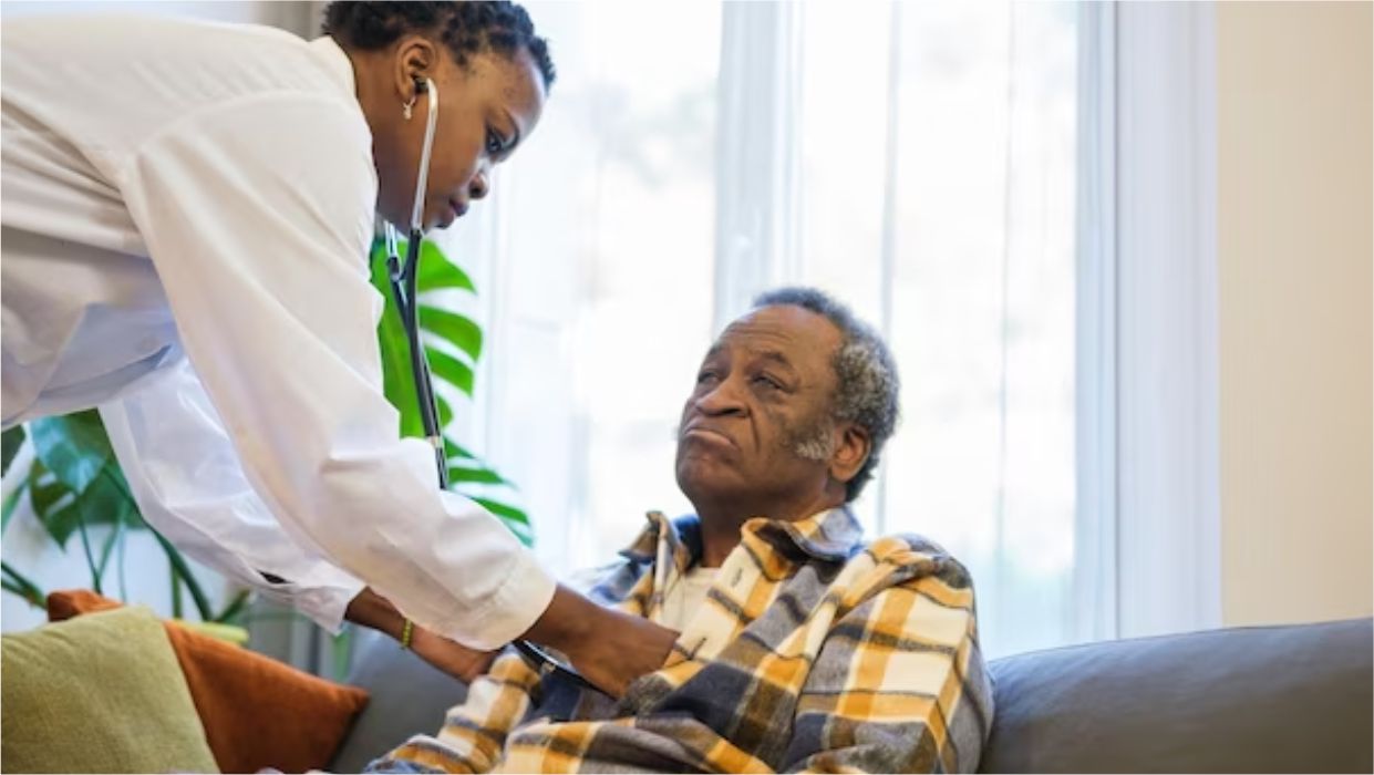 image of a health worker attending to an old patient