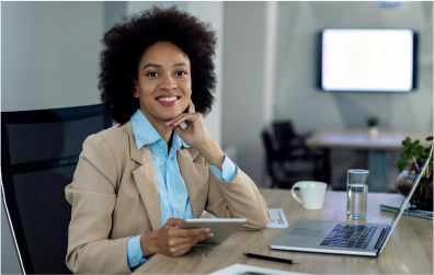 image of a happy black woman on her office desk