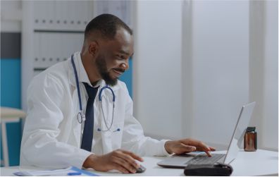 image of a doctor working on his laptop